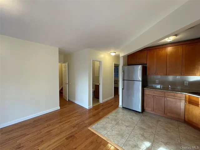 a view of a kitchen with a sink and refrigerator