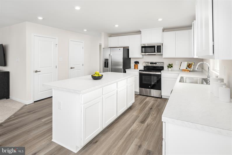 6416 Draft Way, Unit HAZEL Fredericksburg, VA 22407 - Photo 7 of 26 a kitchen with white cabinets and stainless steel appliances