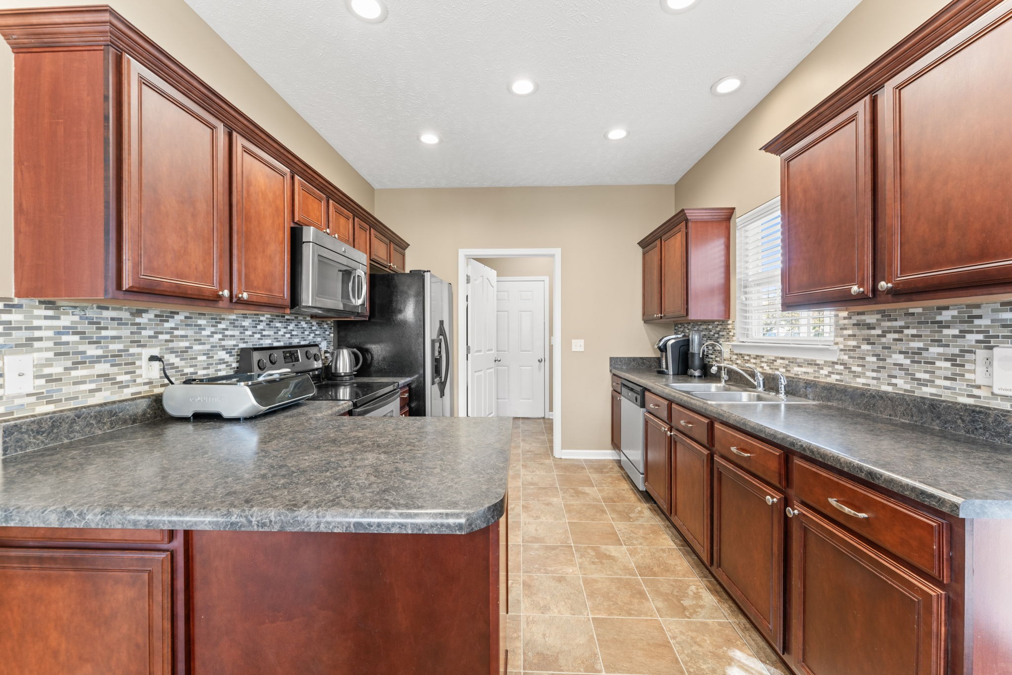 3339 Cotswold Lane Murfreesboro, TN 37128 - Photo 9 of 19 a kitchen with stainless steel appliances granite countertop a stove a sink dishwasher a refrigerator and cabinets with wooden floor