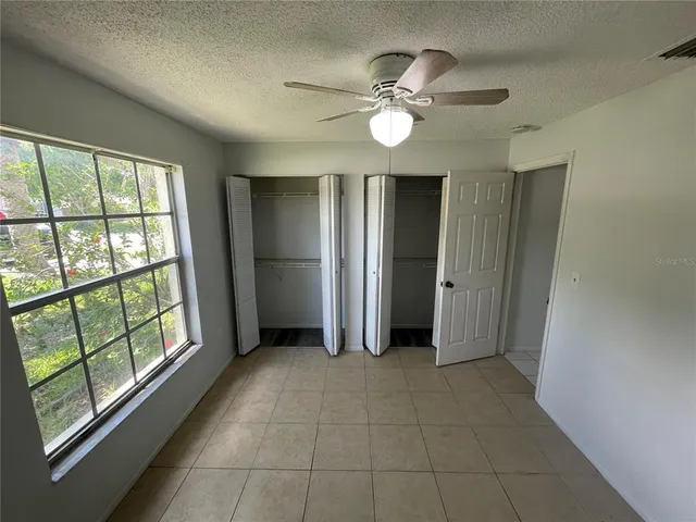 a kitchen with stainless steel appliances granite countertop a stove a sink and white cabinets with wooden floor
