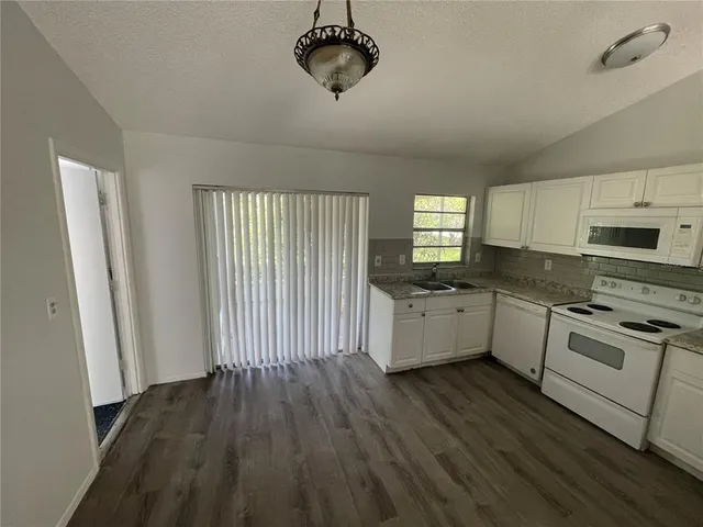 an empty room with an entrance to other room