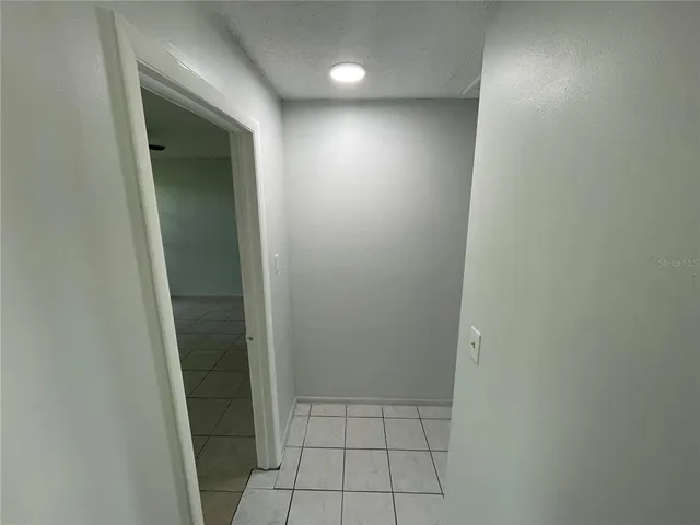 a view of a livingroom with a ceiling fan and window