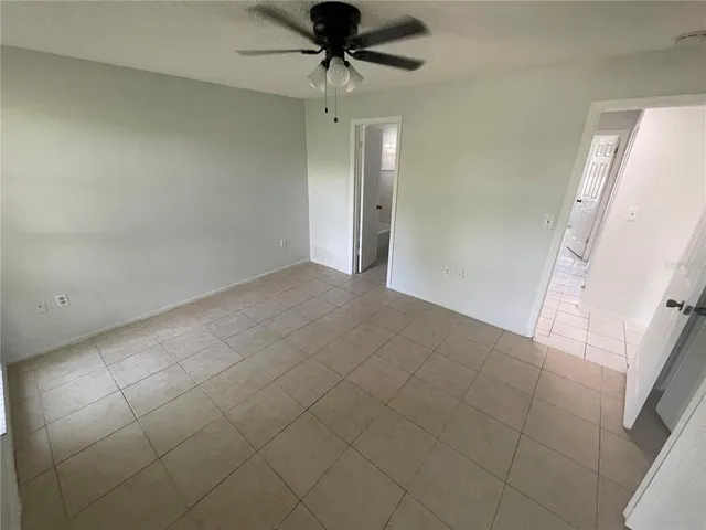 a white toilet and tub sitting next to a window