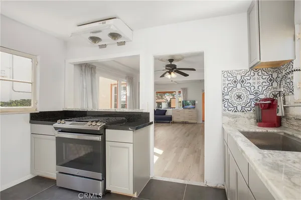 a kitchen with stainless steel appliances granite countertop a stove and a sink