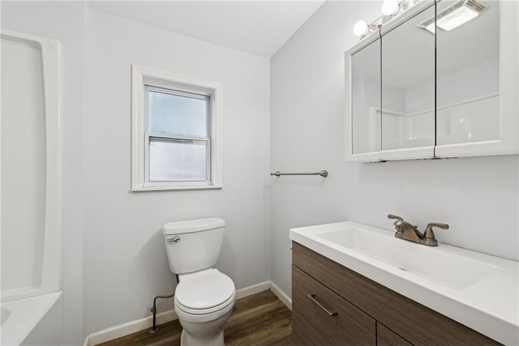 4416 Woolslayer Way Pittsburgh, PA 15224 - Photo 14 of 21 a bathroom with a sink a toilet and a vanity
