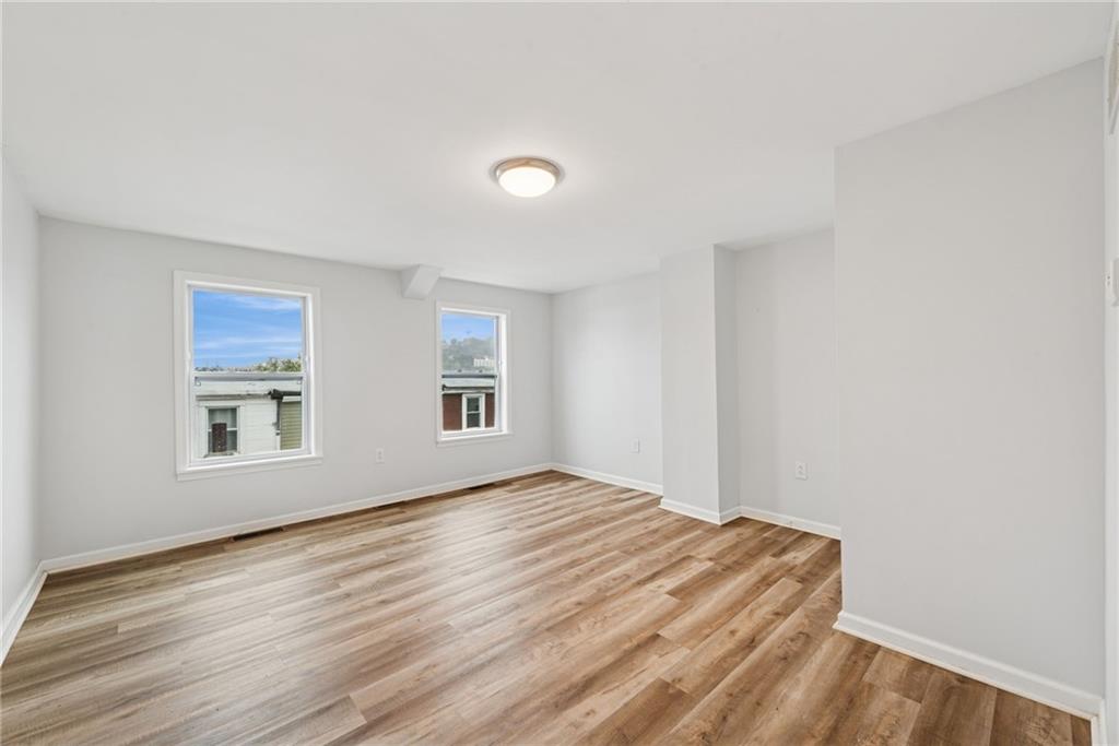 4416 Woolslayer Way Pittsburgh, PA 15224 - Photo 18 of 21 a view of empty room with wooden floor and fan