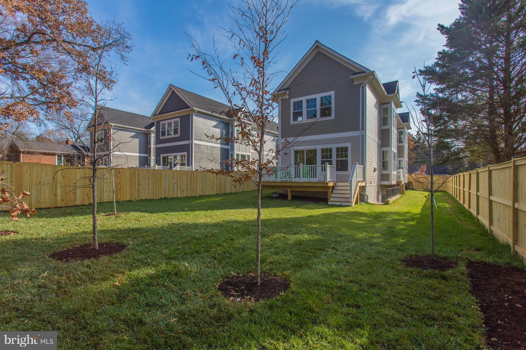 8111 Wellington Road Alexandria, VA 22308 - Photo 5 of 30 Lush and fully fenced backyard with large deck