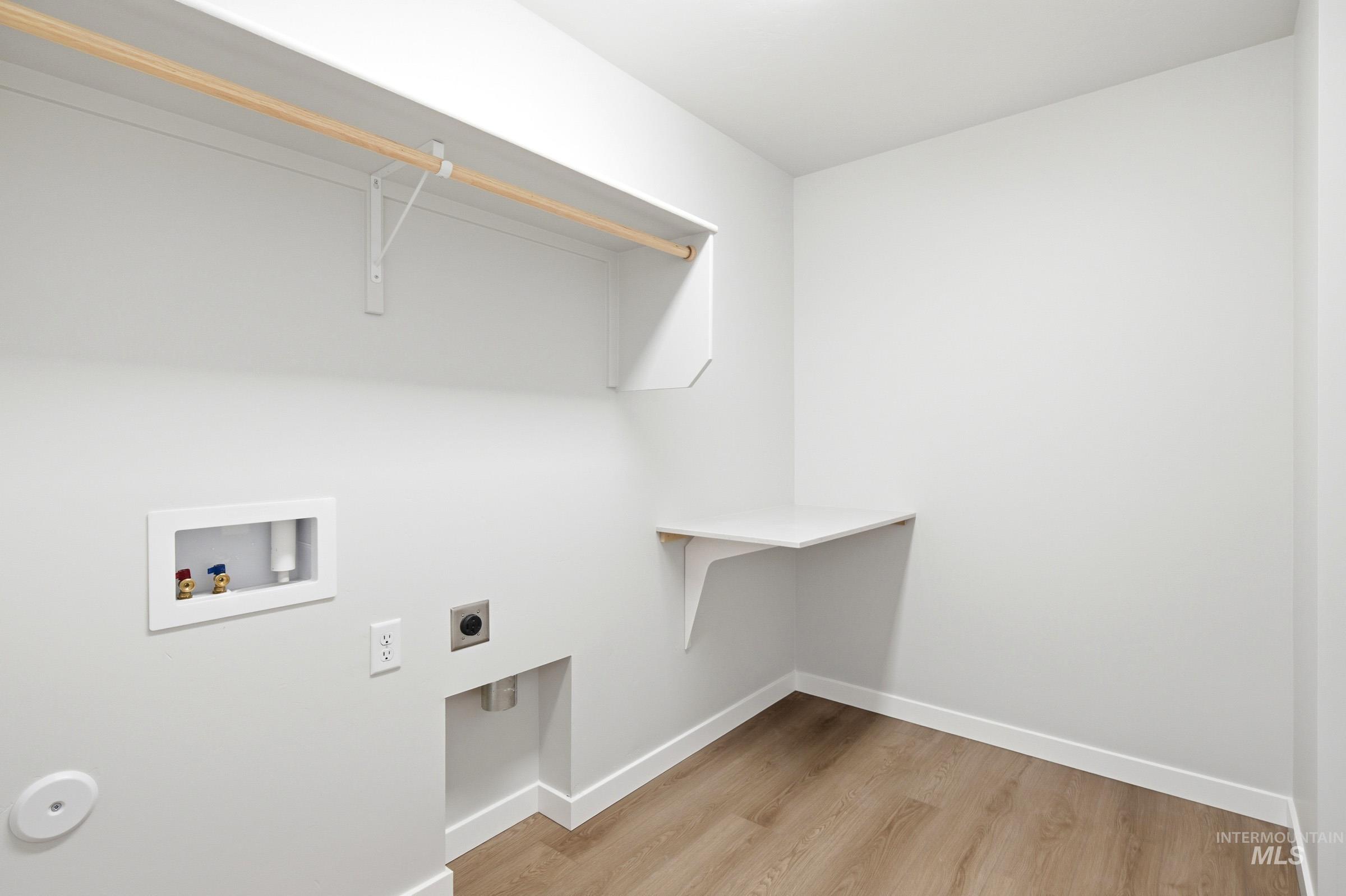 1184 West Jasper Street Meridian, ID 83642 - Photo 15 of 18 Dedicated laundry area featuring wood-finish flooring, white walls, and a built-in folding shelf