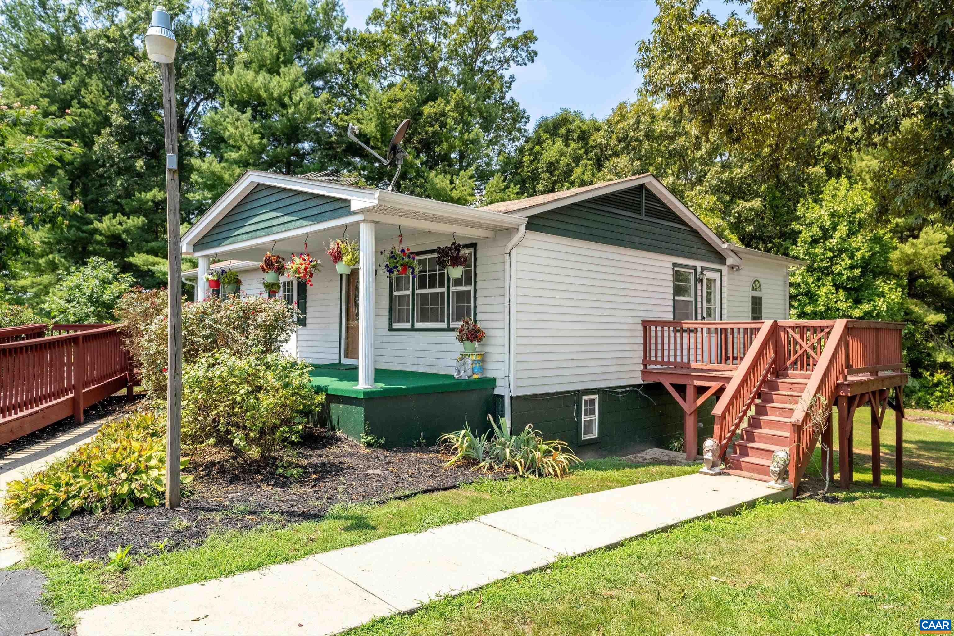 a front view of house with a garden