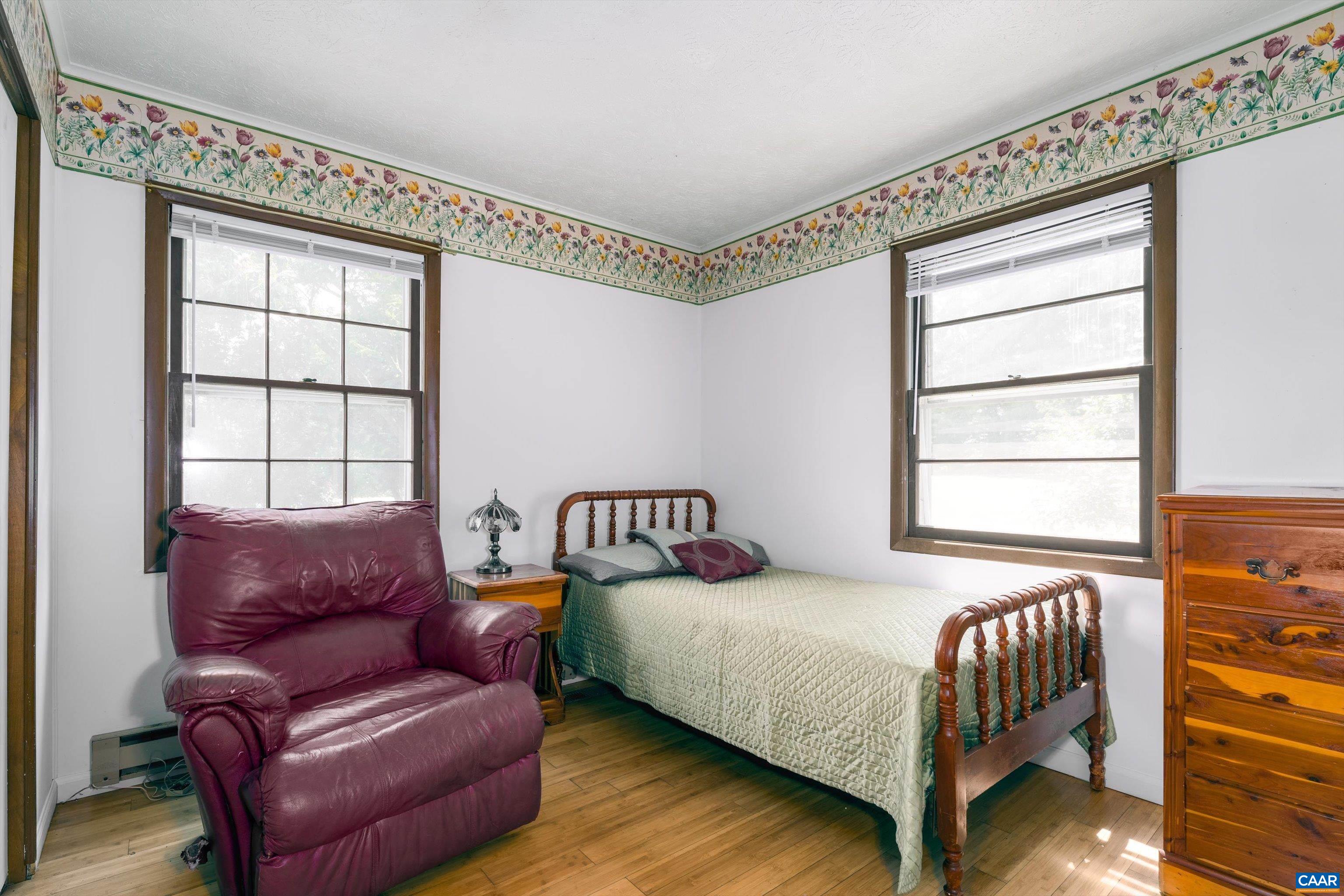 579 Miller Mountain Road Stanardsville, VA 22973 - Photo 12 of 27 a bedroom with a bed couch and window