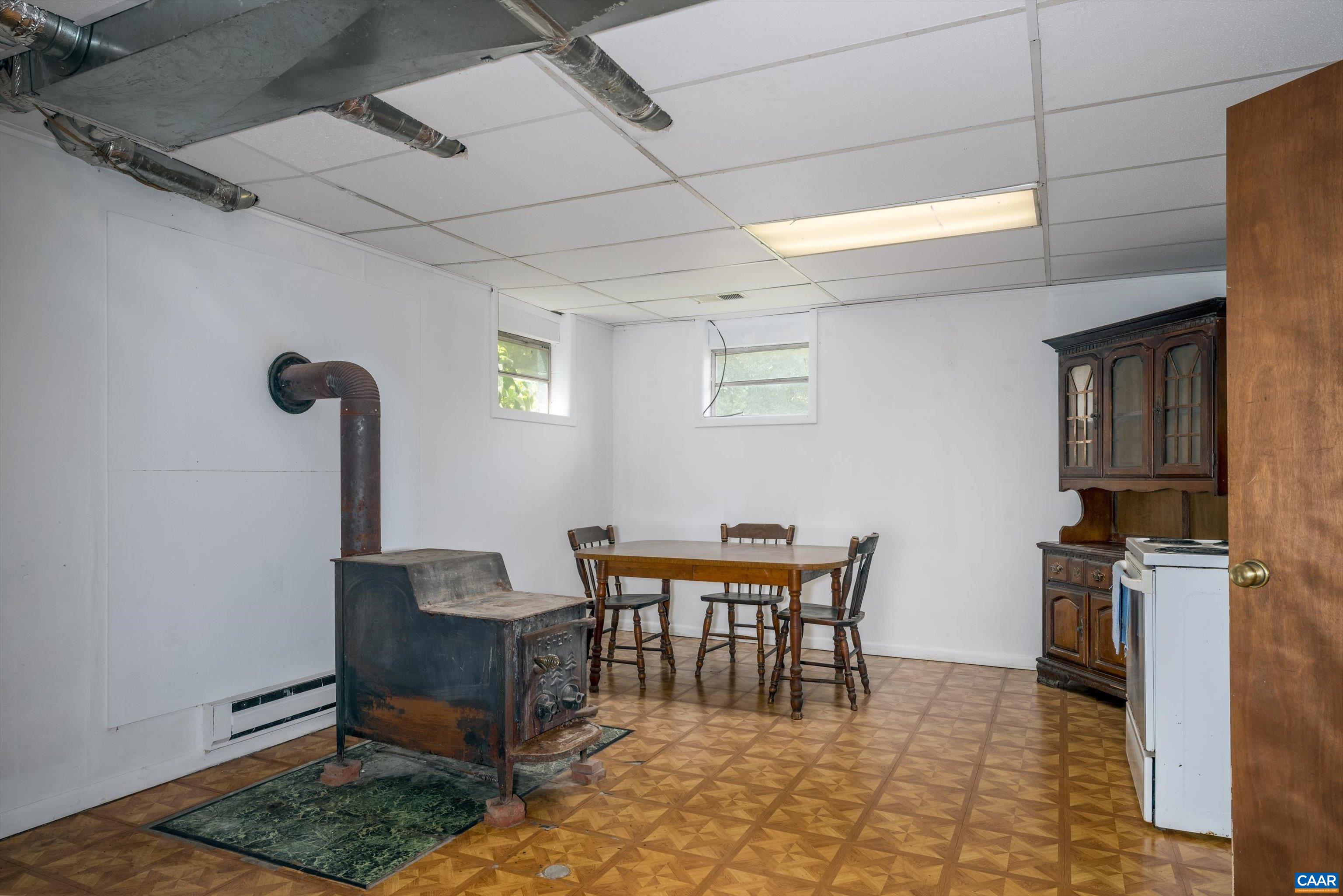 579 Miller Mountain Road Stanardsville, VA 22973 - Photo 17 of 27 a dining room with furniture and a rug