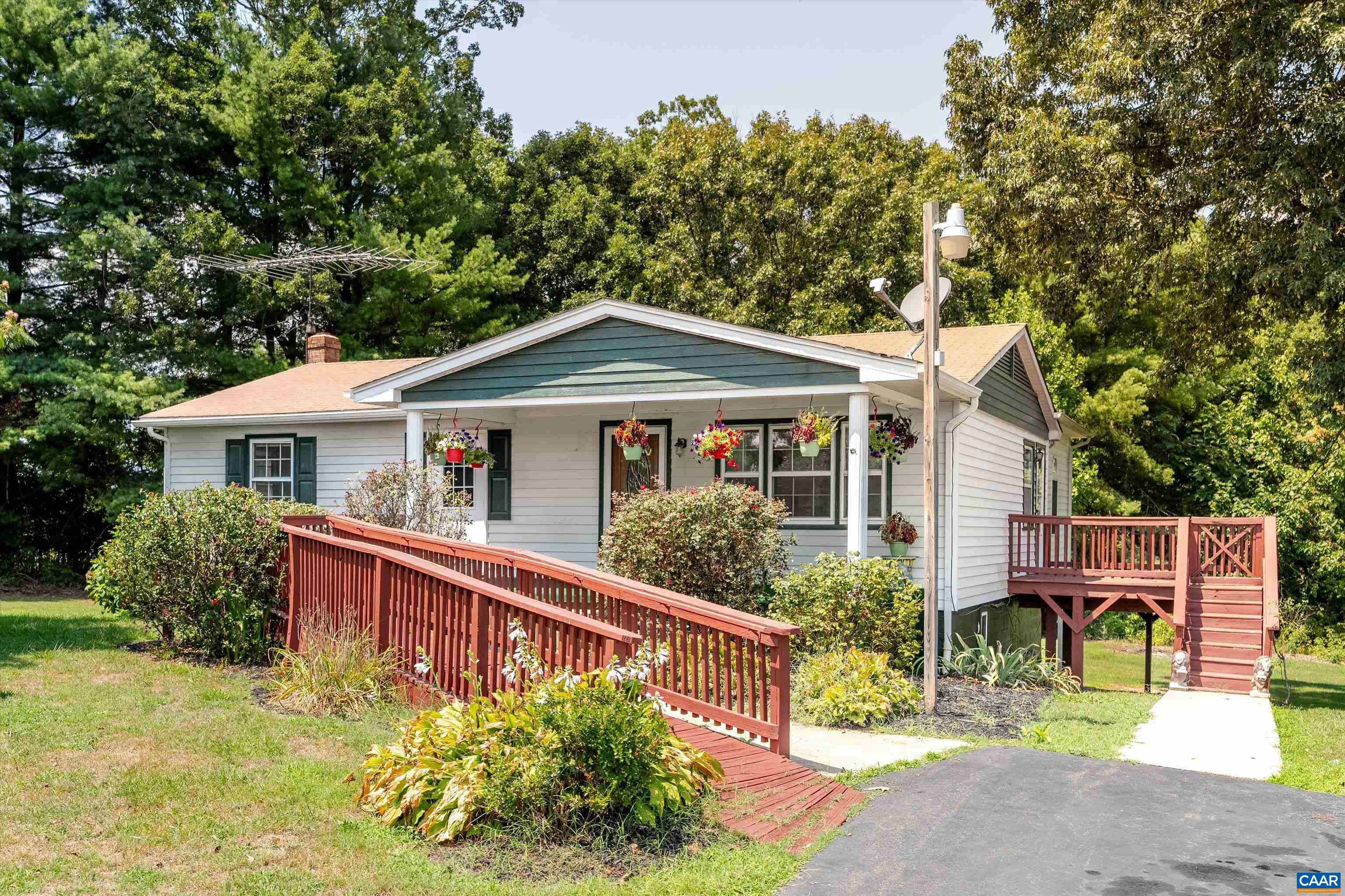 579 Miller Mountain Road Stanardsville, VA 22973 - Photo 2 of 27 a front view of a house with a garden