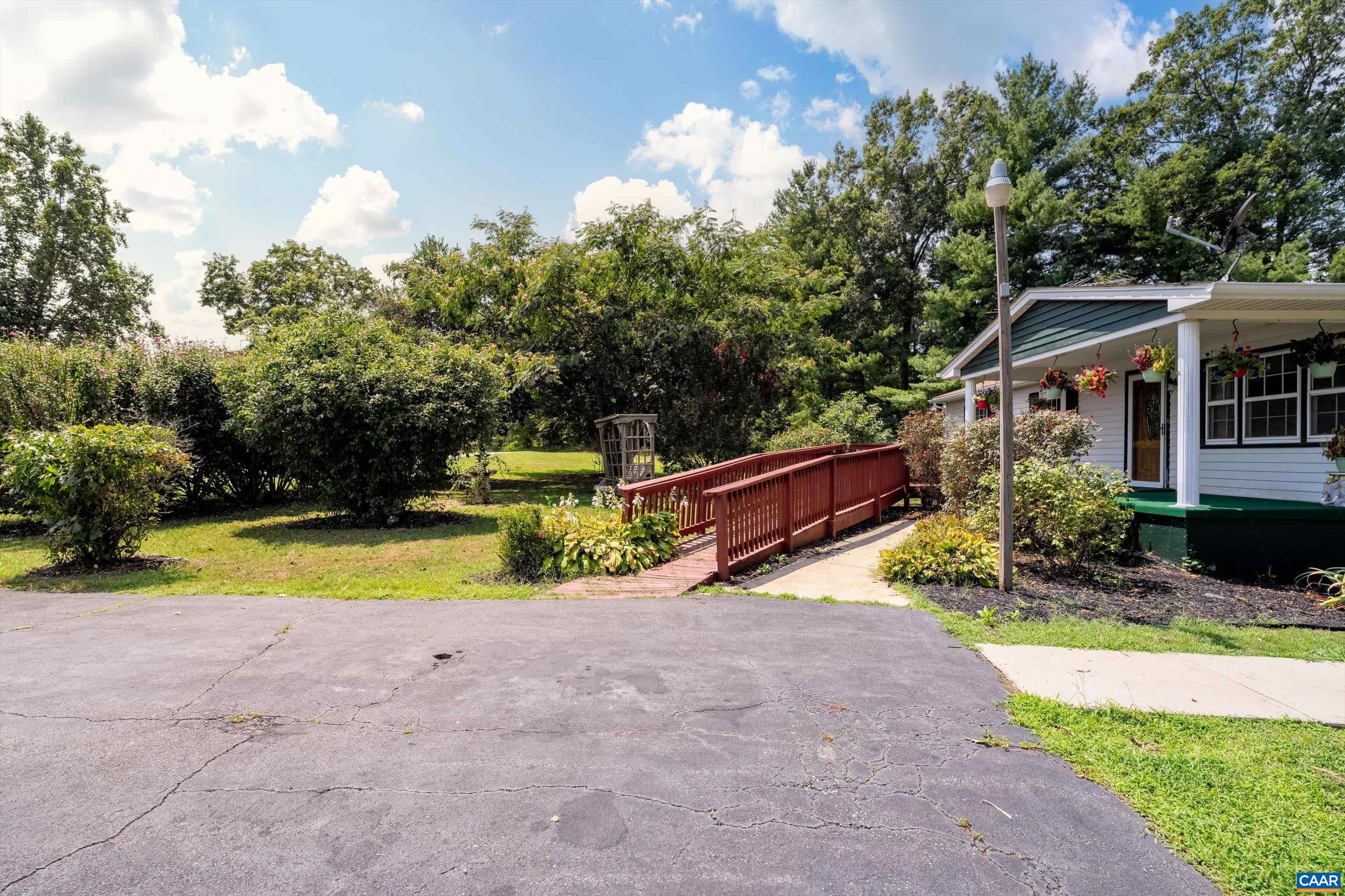 579 Miller Mountain Road Stanardsville, VA 22973 - Photo 25 of 27 a view of a house with swimming pool and sitting area