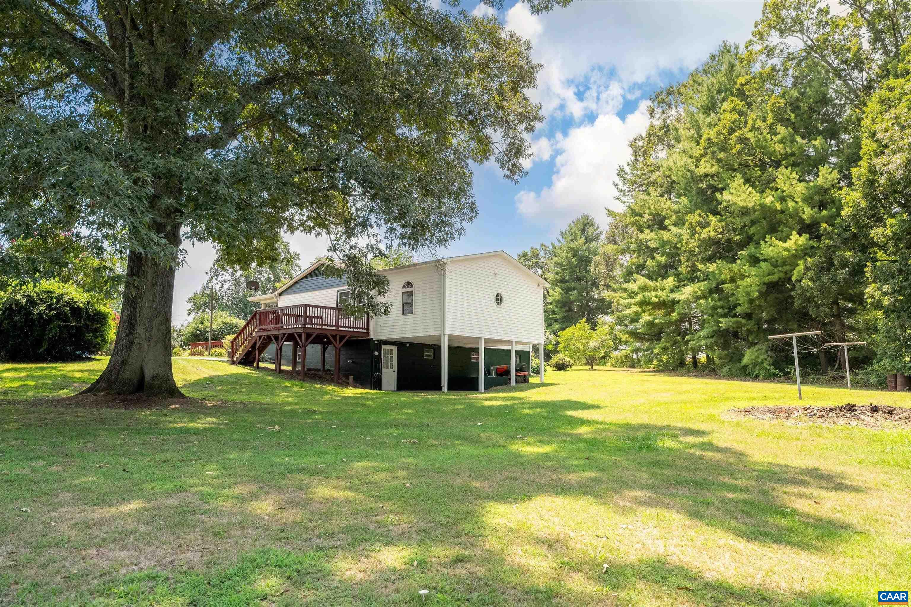 579 Miller Mountain Road Stanardsville, VA 22973 - Photo 26 of 27 a view of a swimming pool with a lawn chairs and a big yard