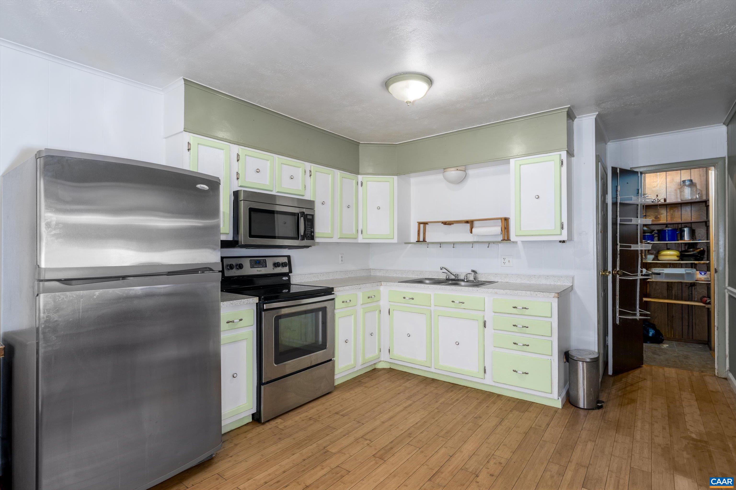 579 Miller Mountain Road Stanardsville, VA 22973 - Photo 4 of 27 a kitchen with stainless steel appliances granite countertop a stove a sink and a refrigerator