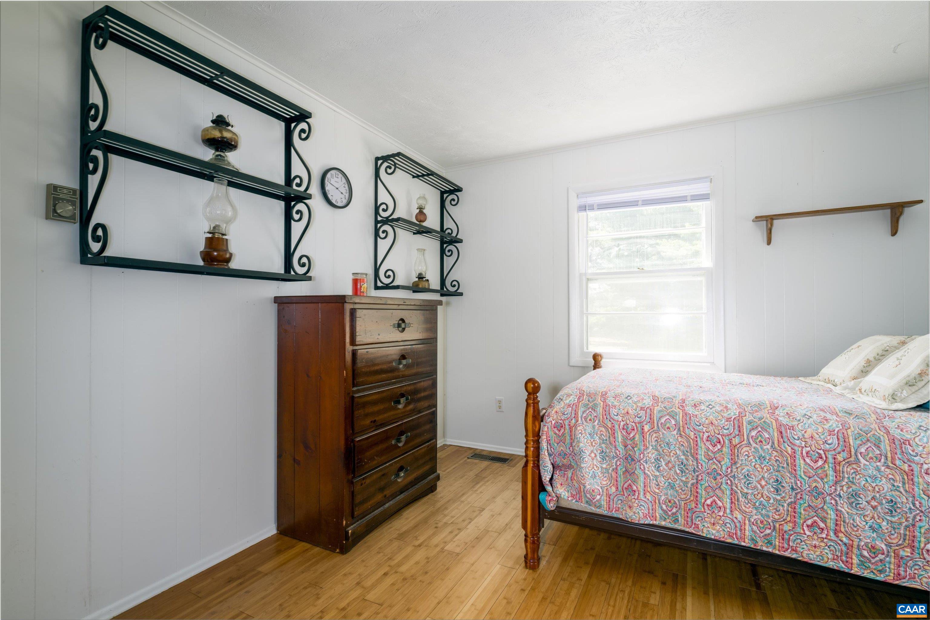 579 Miller Mountain Road Stanardsville, VA 22973 - Photo 10 of 27 a bedroom with a bed and dresser