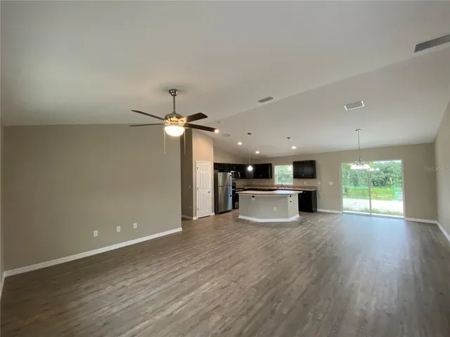 a view of a kitchen with a stove cabinets and wooden floor