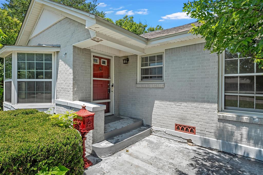 3225 Windsor Avenue Waco, TX 76708 - Photo 2 of 25 Brick exterior with painted finish, featuring a prominent red entry door