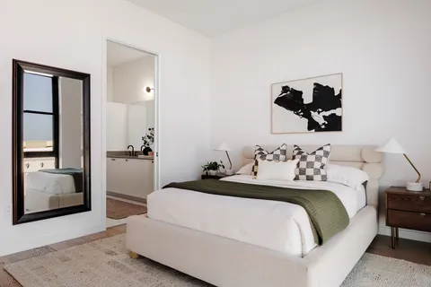 a bedroom with a bed and a couch