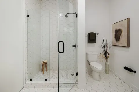 a bathroom with a toilet sink and shower