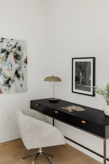 a living room with furniture and a lamp