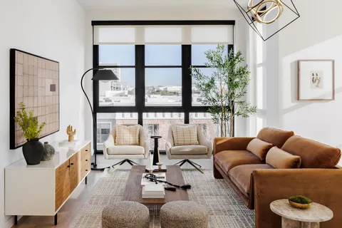a living room with furniture and a floor to ceiling window