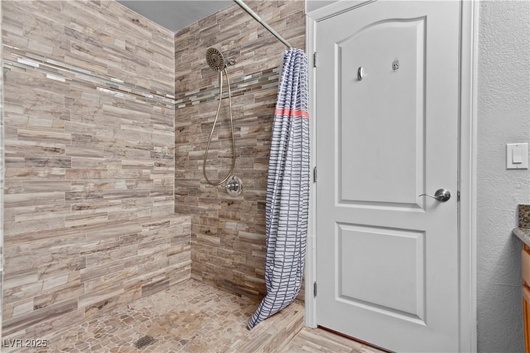 9325 West Desert Inn Road, Unit 141 Las Vegas, NV 89117 - Photo 12 of 30 Bathroom with a shower stall and vanity