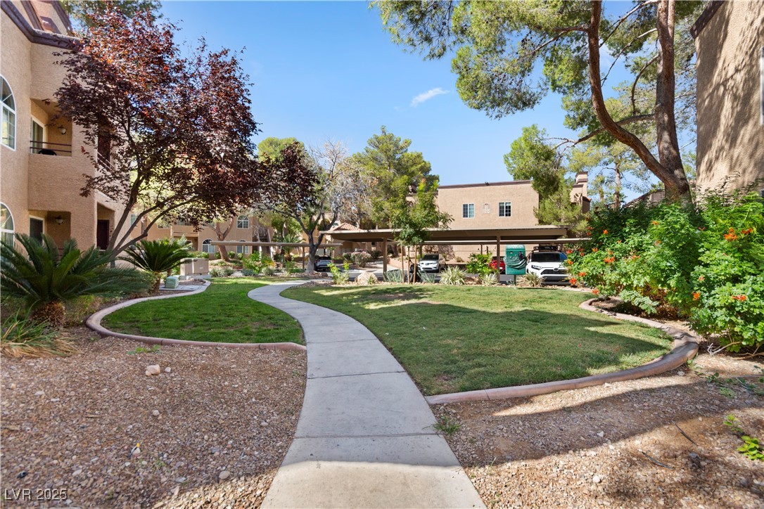 9325 West Desert Inn Road, Unit 141 Las Vegas, NV 89117 - Photo 18 of 30 View of home's community with a lawn
