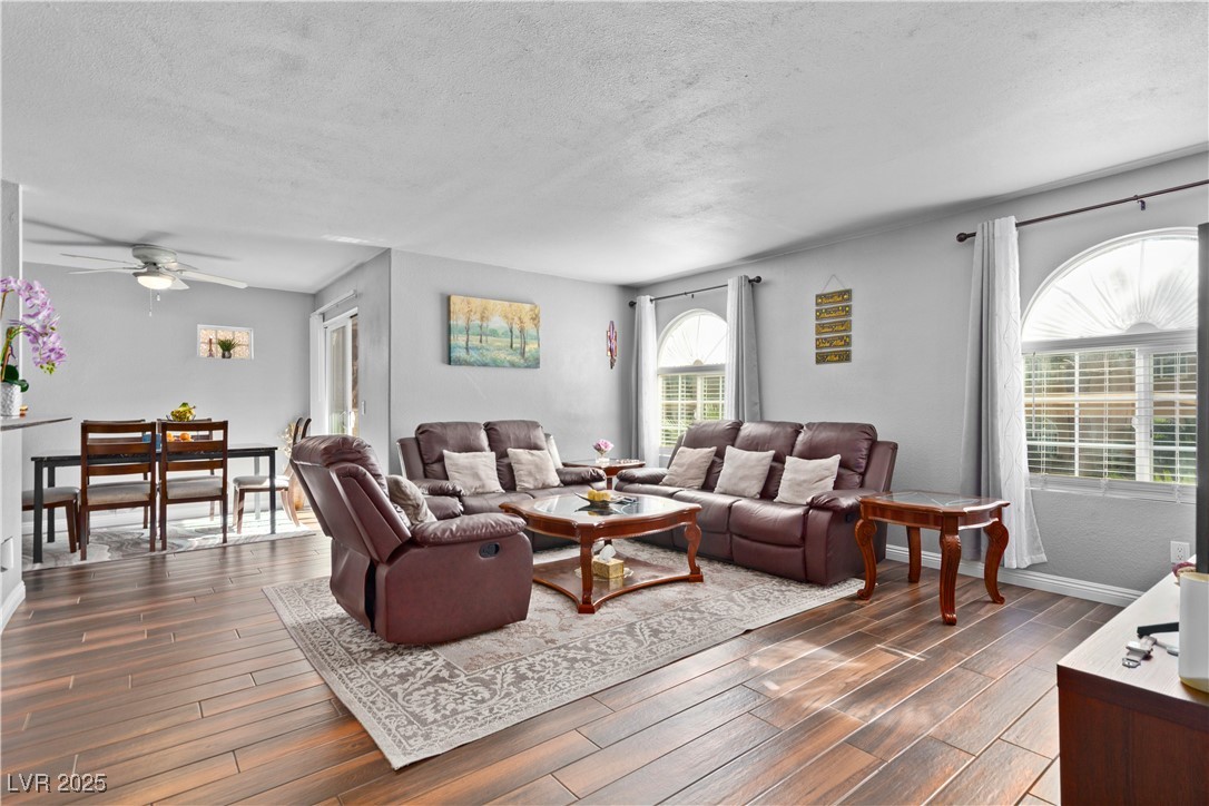 9325 West Desert Inn Road, Unit 141 Las Vegas, NV 89117 - Photo 2 of 30 Living room featuring a textured ceiling, ceiling fan, and dark wood-type tile flooring