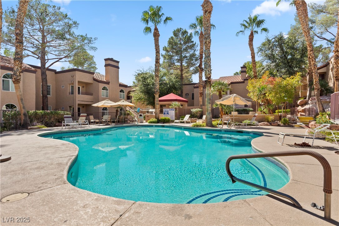 9325 West Desert Inn Road, Unit 141 Las Vegas, NV 89117 - Photo 22 of 30 Community pool featuring a patio area, a gazebo, and a residential view