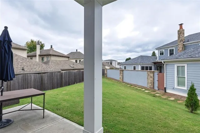 a view of a deck in front of house with a yard