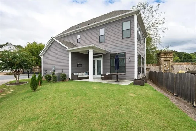 a view of a house with a yard and sitting area