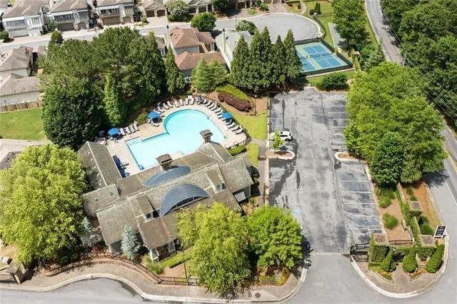 an aerial view of a house with a yard basket ball court and outdoor seating