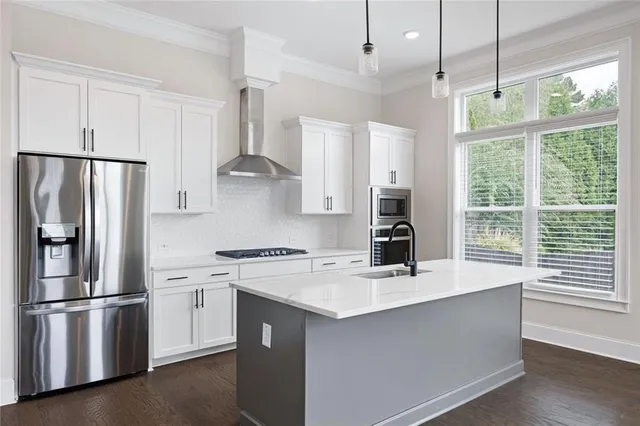 a kitchen with stainless steel appliances a refrigerator sink and cabinets