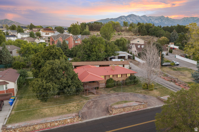 875 Cedar Hollow Road Lehi, UT 84043 - Photo 27 of 76 Property featuring a red-toned roof, an expansive paved driveway, and mature landscaping
