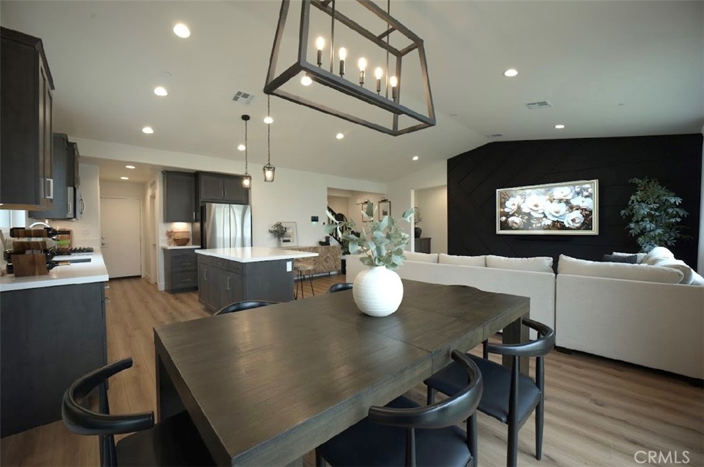 14159 Eclipse Street Moreno Valley, CA 92555 - Photo 11 of 27 a view of a dining room with furniture and wooden floor