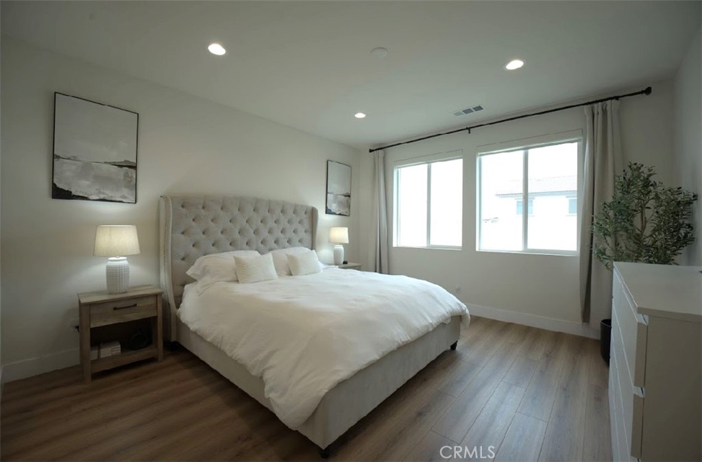 14159 Eclipse Street Moreno Valley, CA 92555 - Photo 16 of 27 a bedroom with a bed and a window