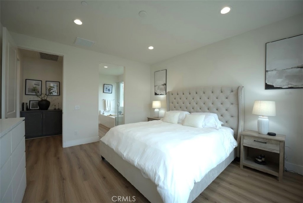 14159 Eclipse Street Moreno Valley, CA 92555 - Photo 17 of 27 a bedroom with a bed and a lamp