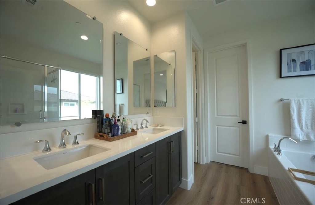 14159 Eclipse Street Moreno Valley, CA 92555 - Photo 19 of 27 a bathroom with a double vanity sink a toilet and a mirror