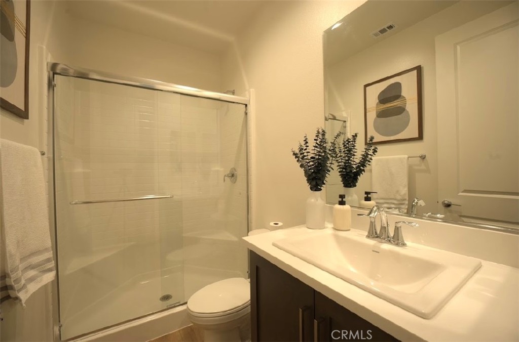 14159 Eclipse Street Moreno Valley, CA 92555 - Photo 20 of 27 a bathroom with a granite countertop sink toilet and shower