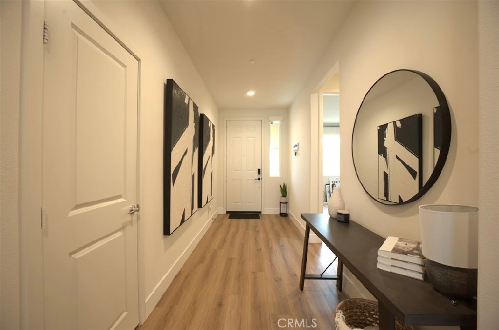14159 Eclipse Street Moreno Valley, CA 92555 - Photo 3 of 27 a view of a hallway with wooden floor and entryway
