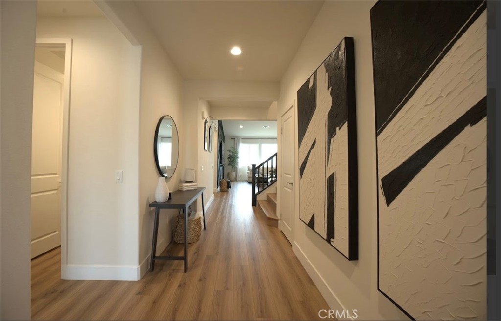 14159 Eclipse Street Moreno Valley, CA 92555 - Photo 4 of 27 a view of a hallway view with wooden floor and staircase