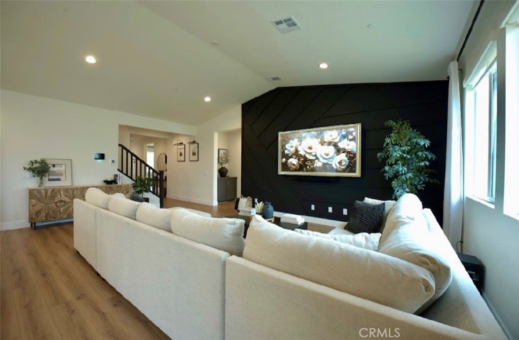 14159 Eclipse Street Moreno Valley, CA 92555 - Photo 8 of 27 a living room with furniture and a flat screen tv