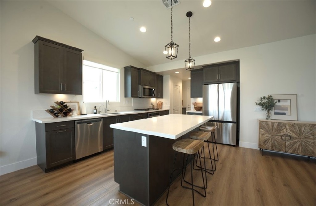 14159 Eclipse Street Moreno Valley, CA 92555 - Photo 10 of 27 a kitchen with a table chairs refrigerator and microwave