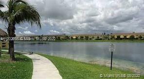 2901 Southeast 13th Road, Unit 20241 Homestead, FL 33035 - Photo 3 of 3 a view of a lake with a yard