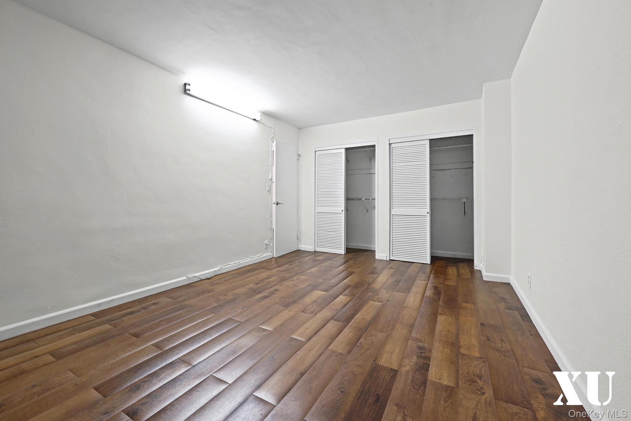 43-10 Kissena Boulevard, Unit 2B Queens, NY 11355 - Photo 14 of 23 a view of an empty room with wooden floor