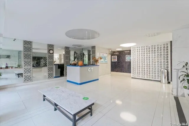 a living room with furniture and view of kitchen