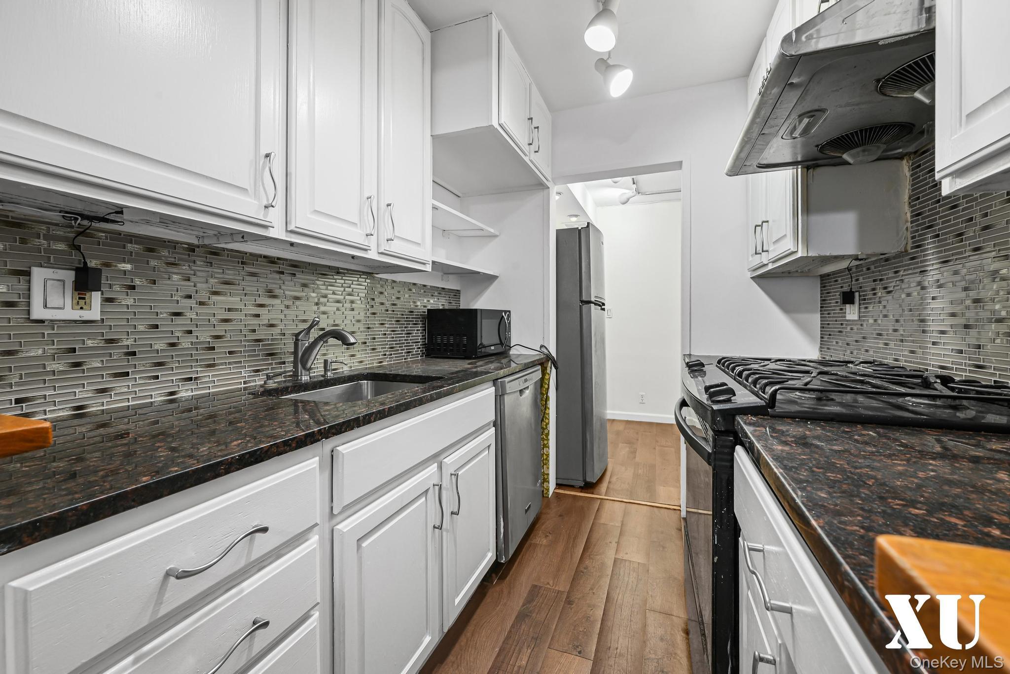 43-10 Kissena Boulevard, Unit 2B Queens, NY 11355 - Photo 4 of 23 a kitchen with stainless steel appliances granite countertop a sink stove and refrigerator