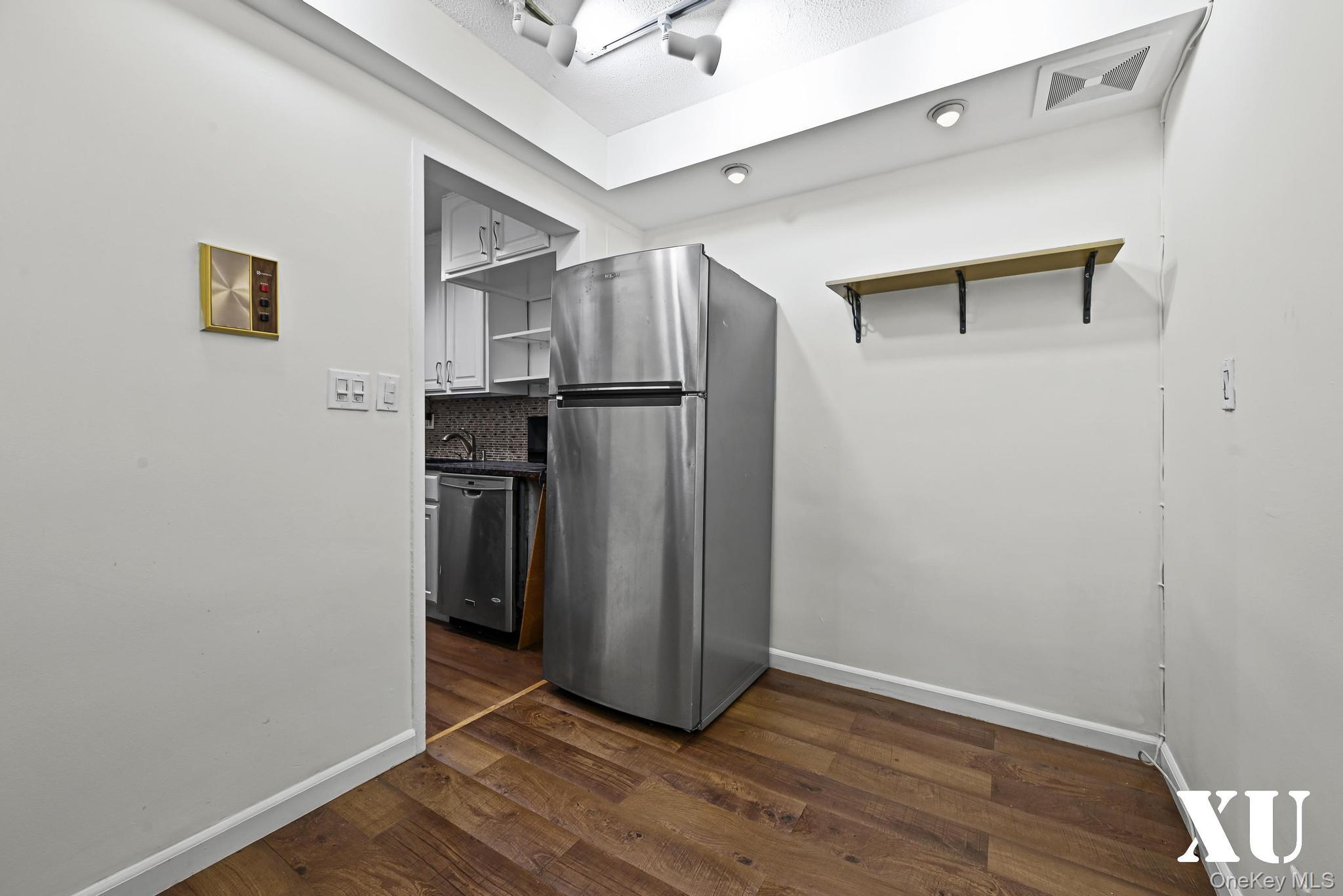 43-10 Kissena Boulevard, Unit 2B Queens, NY 11355 - Photo 5 of 23 a view of a kitchen with a refrigerator and an entryway