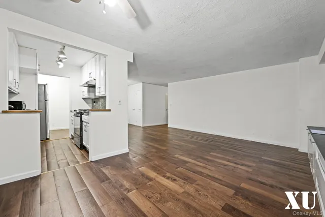 a view of a kitchen with wooden floor and a kitchen